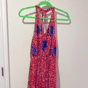 Red-patterned backless dress with blue embroidery tassel fringe on bottom hem